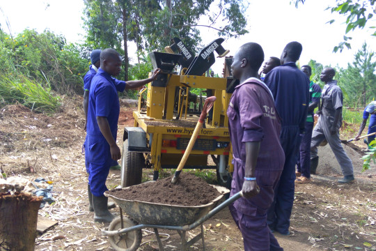 Building students producing blocks using hydro form machine